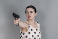 Young woman shoots a gun. Self-defense, short-barreled weapons, weapons permit Royalty Free Stock Photo