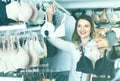 Young woman shopper examining bras