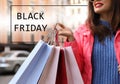 Young woman with shopping bags on city street. Black Friday Sale Royalty Free Stock Photo