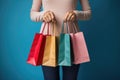 Young woman with shopping bags on color background, closeup. Black Friday sale, Female hand holding many colorful shopping bags on Royalty Free Stock Photo