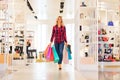 Young woman with shopping bags in the fashion store Royalty Free Stock Photo