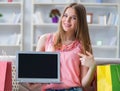 Young woman with shopping bags indoors home on sofa Royalty Free Stock Photo