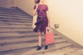 Young woman with shopping bags by stairs at sunset Royalty Free Stock Photo