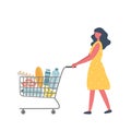 Young woman with shopping cart full of food and drinks Royalty Free Stock Photo