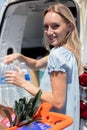 young woman with shopping cart full healthy food