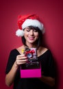 Young woman with shopping cart and gifts Royalty Free Stock Photo