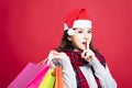 Woman shopping for christmas gifts with secret gesture Royalty Free Stock Photo