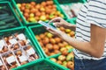 Young woman shopping healthy food in supermarket blur background. Female hands buy nature products using smart phone in store Royalty Free Stock Photo