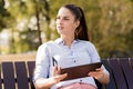 Young woman shopping on-line in the park Royalty Free Stock Photo