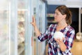 Young woman shopping for milk products at supermarket food department Royalty Free Stock Photo