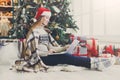 Young woman shopping online in cozy christmas interior Royalty Free Stock Photo