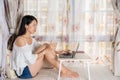 Young woman shopping online by the window Royalty Free Stock Photo