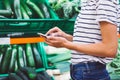 Young woman shopping purchase healthy food in supermarket blur background. Close up view girl buy products using smartphone in sto Royalty Free Stock Photo