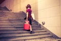 Young woman with shopping walking up stairs Royalty Free Stock Photo