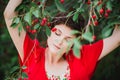 Young woman with short hair-cut standing near cherry tree Royalty Free Stock Photo