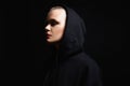 Young woman with short haircut in the Dark. bald girl in Hood