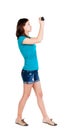 Young woman in shorts photographed something compact camera. Royalty Free Stock Photo