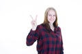 Young woman show hand v two fingers in positive and peace gesture smiling on white background Royalty Free Stock Photo