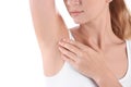 Young woman showing armpit on white background