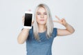 Young woman showing blank smartphone screen Royalty Free Stock Photo