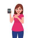 Young woman showing calculator and pointing finger. Trendy girl holding mathematics electronic machine. Female character.