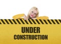 Young woman showing under construction banner Royalty Free Stock Photo