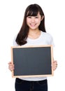 Young woman showing empty chalkboard Royalty Free Stock Photo