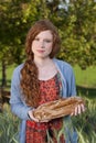 Young woman showing a fresh baken bread Royalty Free Stock Photo