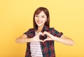 Young woman showing love with hands in heart shape