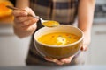 Young woman showing pumpkin soup Royalty Free Stock Photo