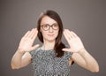 Young woman showing repulsive gesture