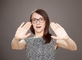 Young woman showing repulsive gesture