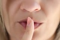 Young woman showing shh gesture or to keep silent sign Royalty Free Stock Photo