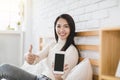 Young woman showing smart phone empty screen to camera Royalty Free Stock Photo