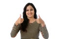 Young woman showing thumbsup gesture against white