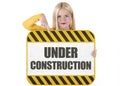 Young woman showing under construction banner Royalty Free Stock Photo