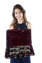 Young woman shows clarinet in open case with velvet lining