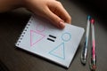 Young woman shows a notebook with drawn symbols of a woman and a man and an equal sign. concept of gender equality Royalty Free Stock Photo