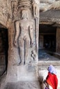 Young woman shyly looking at an ancient statue of naked Jaina Royalty Free Stock Photo