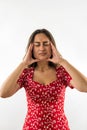 young woman is sick and has a headache isolated on a white background. Royalty Free Stock Photo