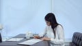 Young woman signing formal documents sitting at the cafe table Royalty Free Stock Photo