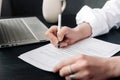 A young woman signing an official document, a woman& x27;s hand with a pen signs a paper contract. Business, lawyer Royalty Free Stock Photo