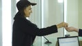 Young woman signing papers to check in at the hotel