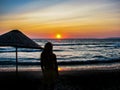 Young woman silhouette stay on the beach by the sea.