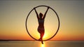 Young woman silhouette at sunrise doing morning excercise. Royalty Free Stock Photo