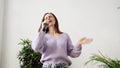 Young woman sing at home. Karaoke black microphone. House lyrics dance.