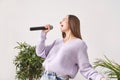 Young woman sing at home. Karaoke black microphone. House lyrics dance.