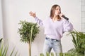 Young woman sing at home. Karaoke black microphone. House lyrics dance.