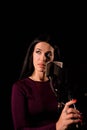 Young woman singer in front of microphone.