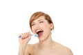 Young woman singing to tooth brush Royalty Free Stock Photo